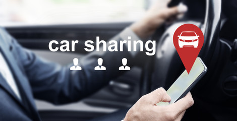 Man driving car and using mobile app of rental service