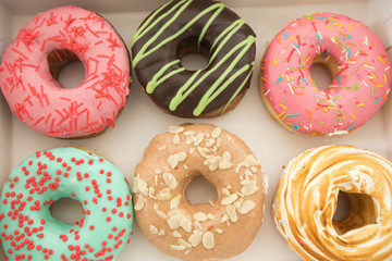 Various donuts lying in box