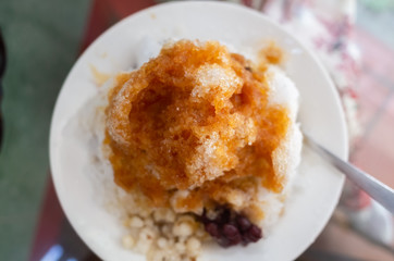 eating shaved ice with colorful dessert