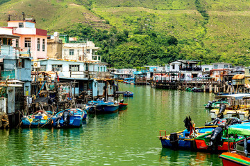 Famous tourist attraction in Hong Kong. Old houses standing in the water in fishing village Tai O,...