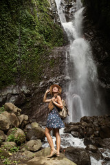 Woman near waterfal on Bali, Indonesia 