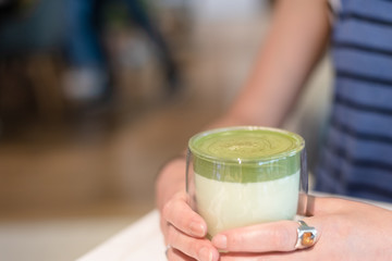 cup of matcha milk tea on table
