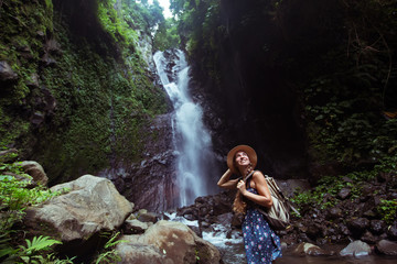 Fototapeta premium Woman near waterfal on Bali, Indonesia&nbsp;
