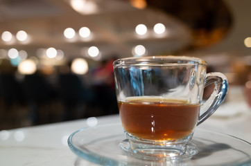 cup of coffee in glass on table