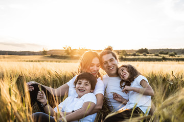 Portrait of a happy and fun family in the countryside. Concept of united family smiling