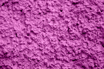 An old ragged plaster purple wall texture, cracked and old  for background,rough cement wall