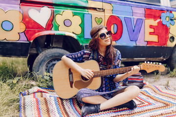 full of joyful feeling satisfaction for beautiful blonde young woman playing alone the acoustic guitar with the wind on his hair in summer time vacation leisure. pretty lady lifestyle.