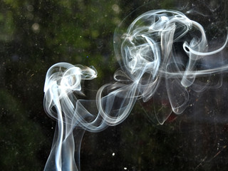background abstract of white whisp of smoke from incence stick smoking kills air dust