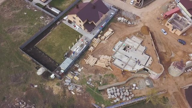 Aerial view of construction site in progress, basement floor of future cottage industrial area. Clip. Top view of a construction site where a new villa is being built.