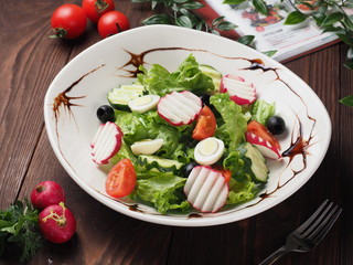 Spring salad with quail eggs, tomatoes and cucumbers
