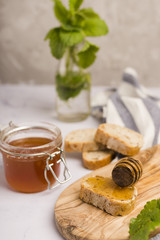 Glass jar full of honey with honey spoon