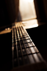 Fototapeta premium Acoustic Guitar In Music Studio Close up. Shined By The Sun At The Golden Hour