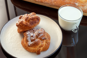 Fresh tasty bread with milk on the background of nature in summer.