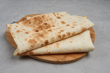 thin Armenian bread on a wooden board