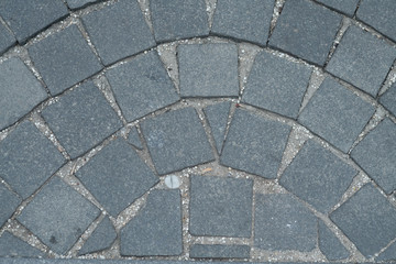 Obraz premium Stone pavement texture, granite cobblestoned pavement background, cobbled stone road regular shapes, abstract background of old cobblestone pavement close-up