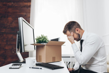 Businessman clearing his desk after being made redundant