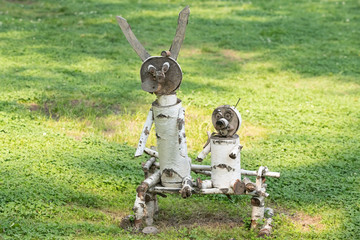 hand-made wooden sculpture of birch on the background of grass in the Park