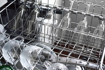 Clean wine glasses, glasses and cups are dishwasher safe. Modern kitchen appliances.