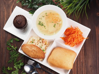 Chicken cutlet with rice in a bento set on a wooden rustic table