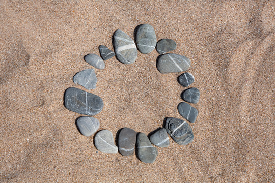 Circle Made Of Pebble In Sand