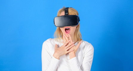 Woman watching virtual reality vision. Woman using VR device. Woman wearing virtual reality goggles in blue background. Futuristic 3d.