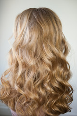 Naklejka premium blond with perfect curls, long hair with curls,