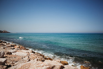 the waves of the sea beat against the stones