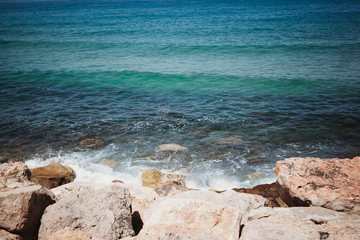 the waves of the sea beat against the stones