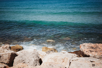 the waves of the sea beat against the stones