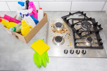 Cleaning a gas stove with kitchen utensils, household concepts, or hygiene and cleaning.
