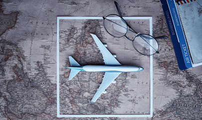 Travel concept. Map on the table andl aircraft.