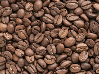 Coffee beans closeup background. Roasted coffee beans texture top view