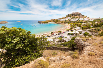 Fototapeta na wymiar Idyllic Paradise landscape of the resort town of Lindos on the island of Rhodes, Greece. The concept of holidays in the tropics and historical cities