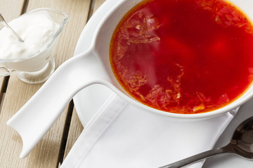 Top view Borscht, ukrainian cuisine sour soup, with meat, potato, beetroots. food background. Red soup in bowl with copy space for design. photo for menu