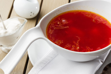 Top view Borscht, ukrainian cuisine sour soup, with meat, potato, beetroots. food background. Red soup in bowl with copy space for design. photo for menu