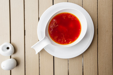 Top view Borscht, ukrainian cuisine sour soup, with meat, potato, beetroots. food background. Red soup in bowl with copy space for design. photo for menu