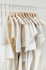 Feminine clothes on hanger. Minimal fashion composition on white background. Modern fashion blog...