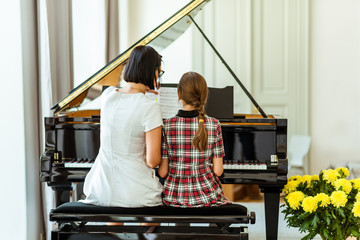 Music. Education. Lesson in music school. Teacher and pupil. Music lesson at the piano