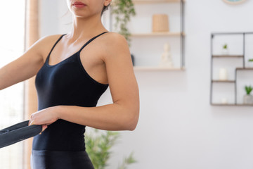 Young woman exercising on pilates reformer bed