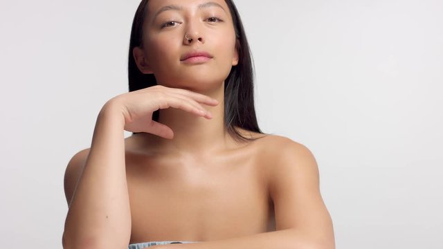 mixed race asian model in studio beauty shootpanned video nodel touches her face slightly
