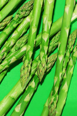 bunch of asparagus on green background