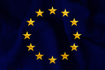 blue flag of the European Union on the dense burlap