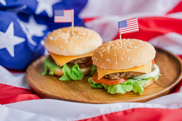 American hamburger or cheeseburger with america flag for USA 4th of July independence day food background concept