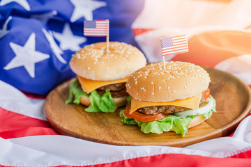 American hamburger or cheeseburger with america flag for USA 4th of July independence day food background concept