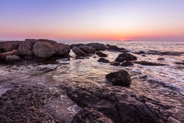 sunrise over the sea coast with rocks