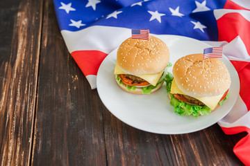 American hamburger or cheeseburger with america flag for USA 4th of July independence day food background concept