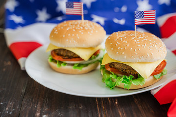 American hamburger or cheeseburger with america flag for USA 4th of July independence day food background concept