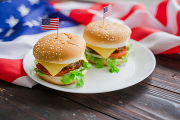 American hamburger or cheeseburger with america flag for USA 4th of July independence day food background concept