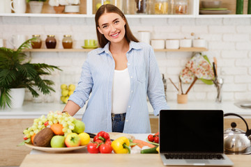 Woman Cooking Salad Showing Laptop With Blank Screen