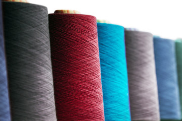 different colors of thread, textile, for clothing manufacture isolated on white background